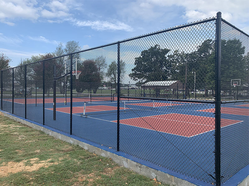 Black PVC-coated chain link fence installed by Thomas Fence in Tontitown, Arkansas