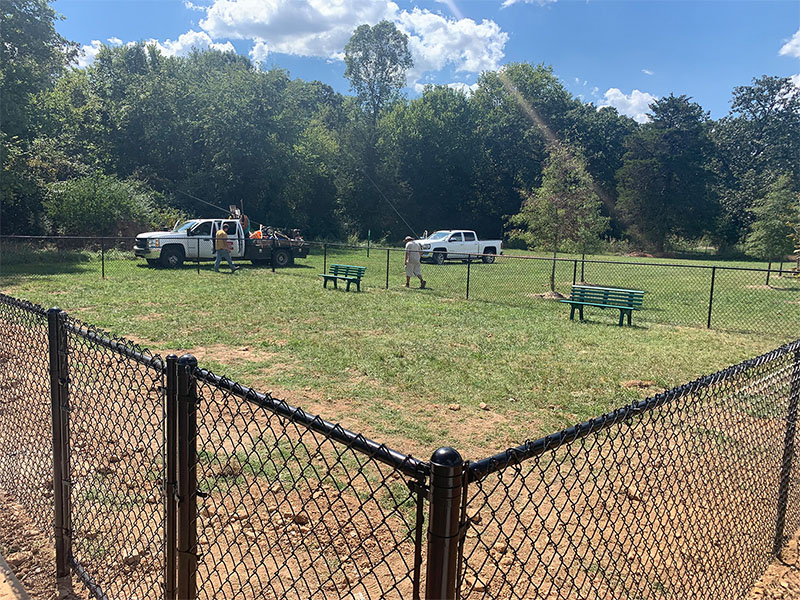 Black vinyl chain link fence at a dog park installed by Thomas Fence in Fayetteville, Arkansas