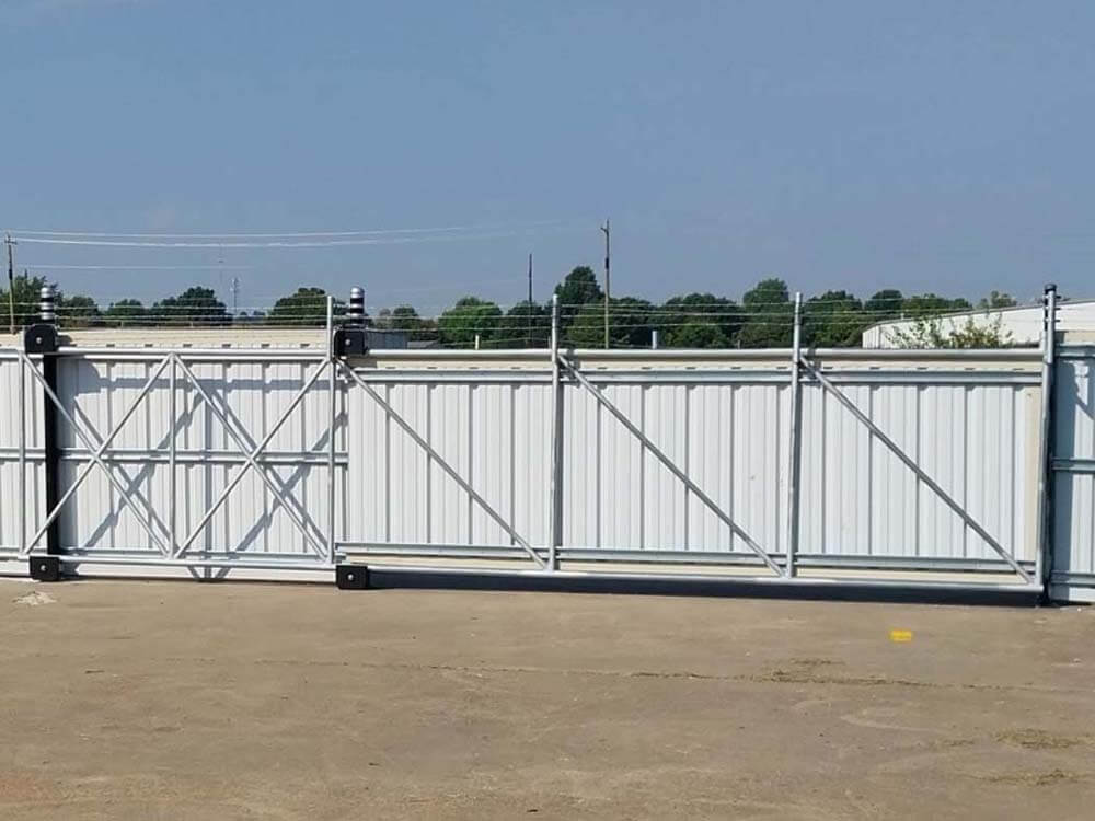 Cantilever slide gate with metal R-panel installed by Thomas Fence in Lowell, Arkansas