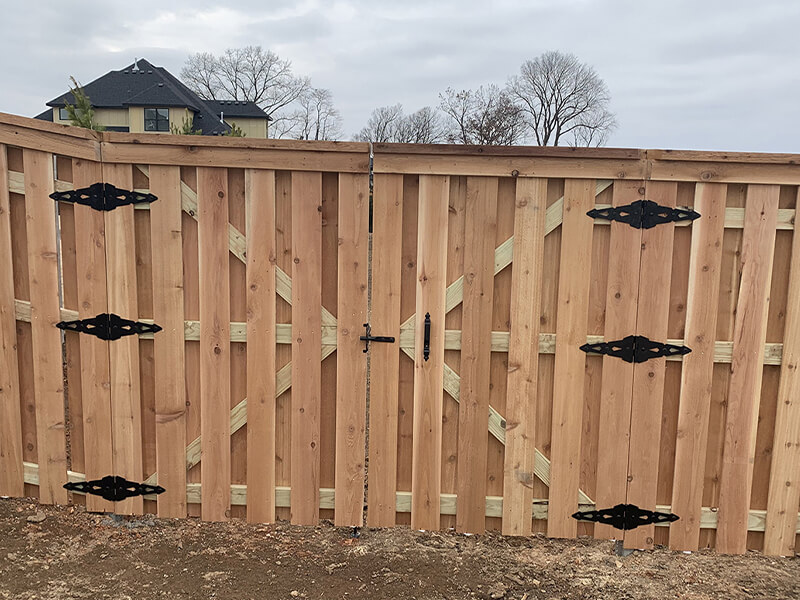 Cedar privacy fence installed by Thomas Fence at a residential property in Bentonville, Arkansas