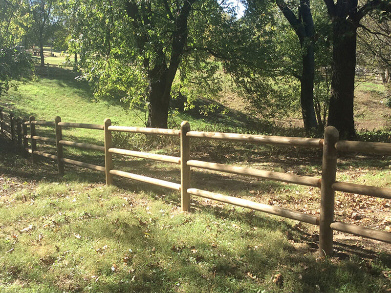 Round rail fence for livestock installed by Thomas Fence in Cave Springs, Arkansas