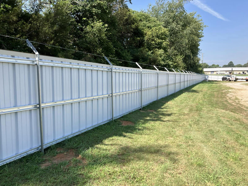 Metal R-panel commercial fence installed by Thomas Fence in Lowell, Arkansas