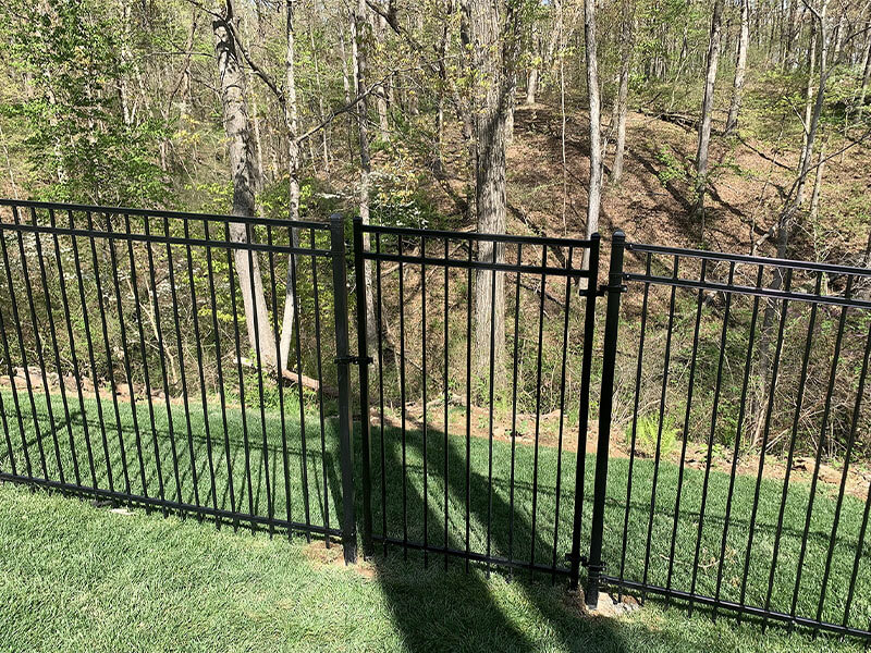 Ornamental steel fence installed by Thomas Fence in a residential backyard in Centerton, Arkansas