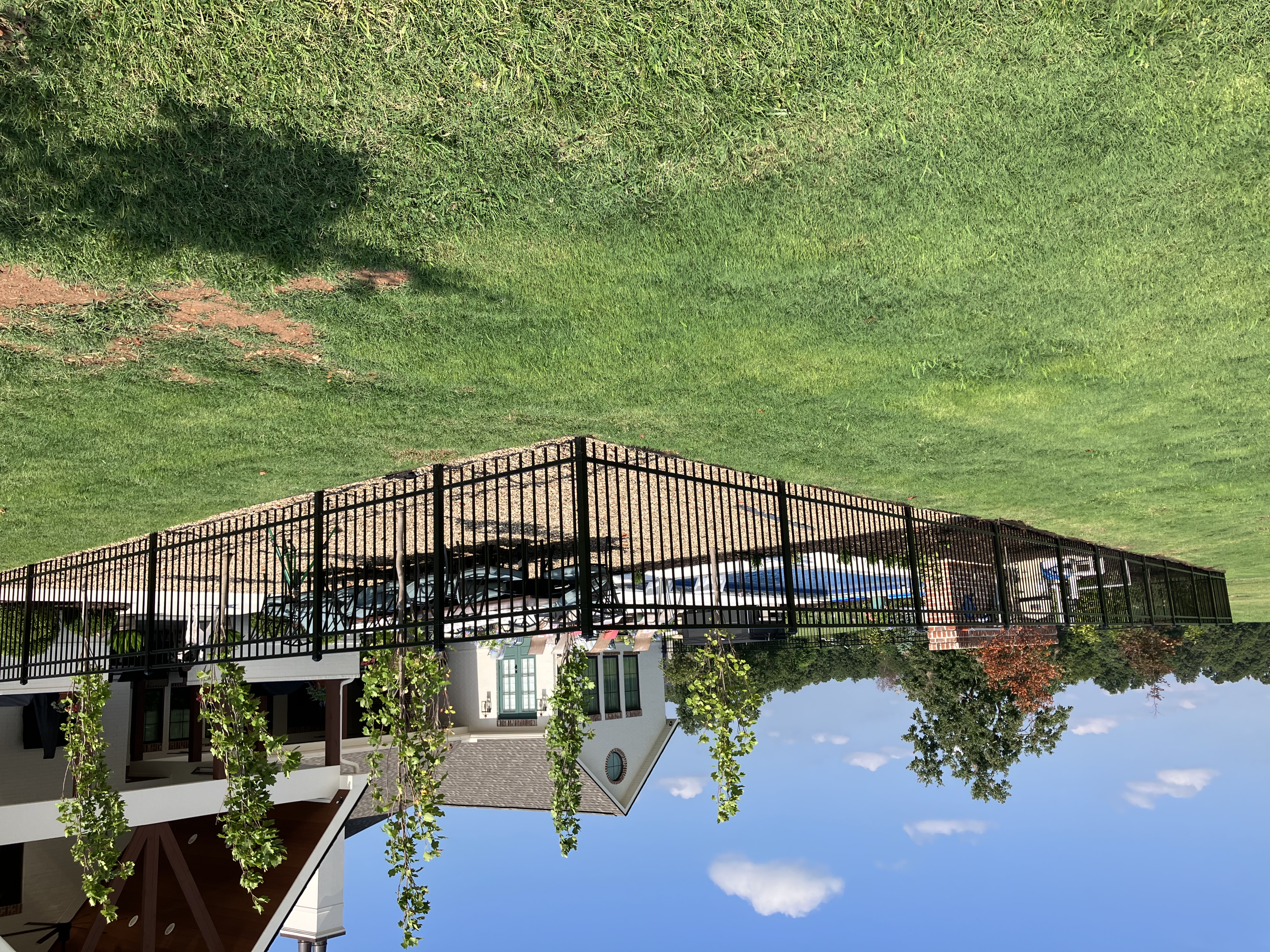 Ornamental steel pool enclosure fence installed by Thomas Fence in Elm Springs, Arkansas