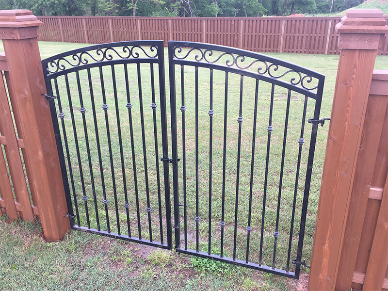 Ornamental steel gate in a residential backyard — Thomas Fence, Bentonville, Arkansas