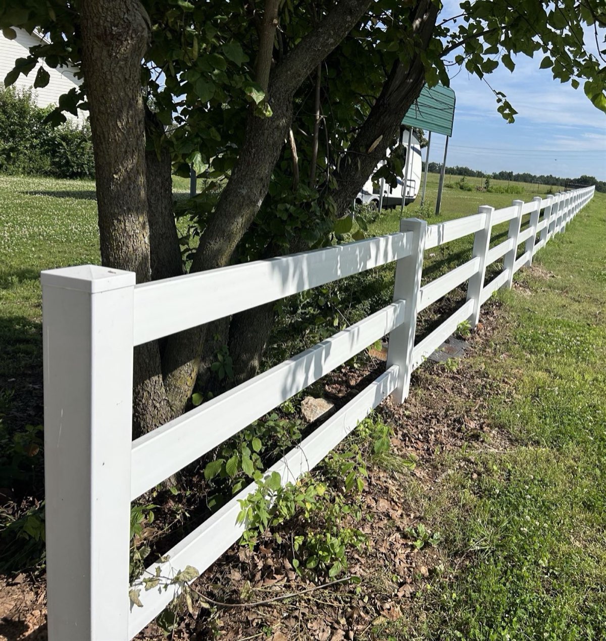 Three-rail white vinyl fence installed by Thomas Fence in Springdale, Arkansas