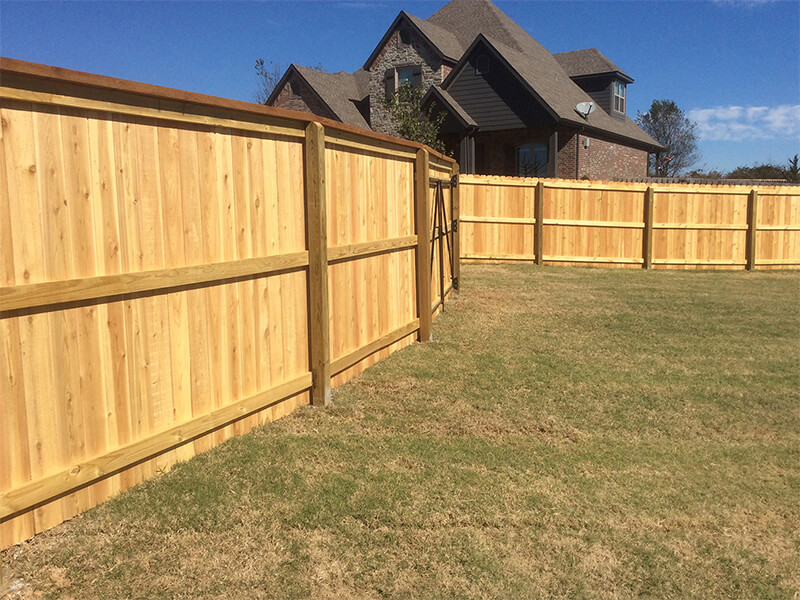 Wood fence installed by Thomas Fence at a residential property in Cave Springs, Arkansas