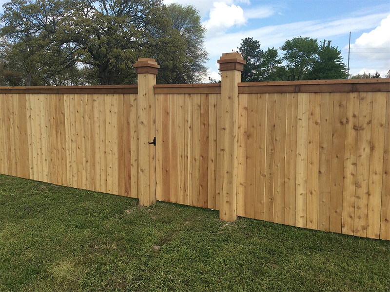 Wood fence with cedar cap and trim installed by Thomas Fence in Siloam Springs, Arkansas